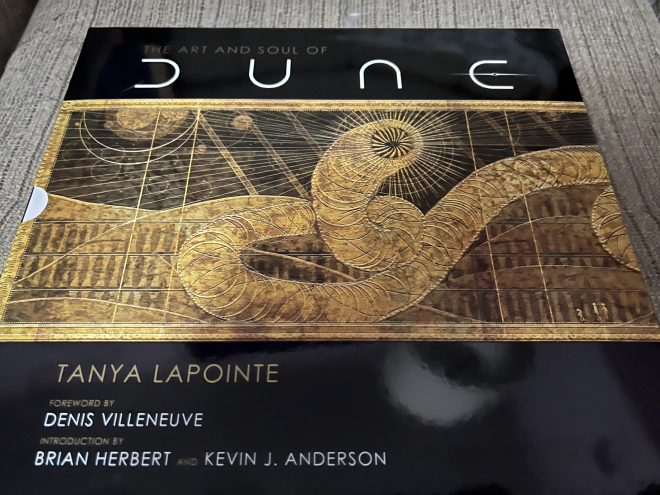 Cover of coffee table book, The Art of Dune, which depicts a stylized drawing of a sand worm.