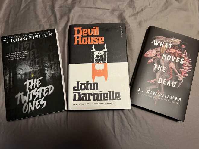 Three novels are pictured arranged in a line. The first is The Twisted Ones by T. Kingfisher, the second is Devil House by John Darnielle, and the third is What Moves the Dead by T. Kingfisher.