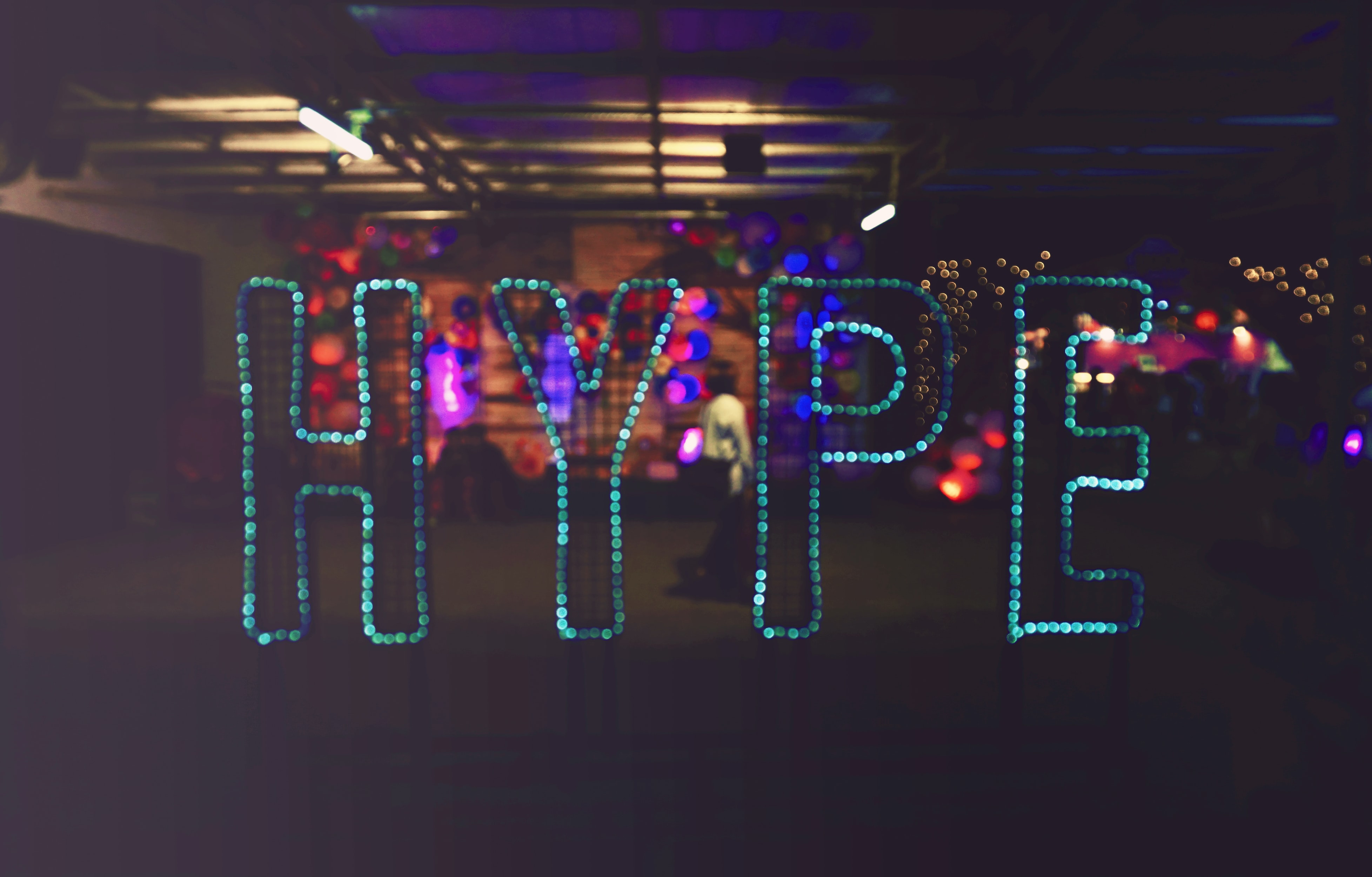 Sign at festival shows the word HYPE spelled out in individual blue lights